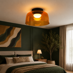 Green ceiling light in a deep teal bedroom.