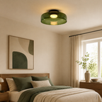 Green ceiling light in a soft neutral bedroom.