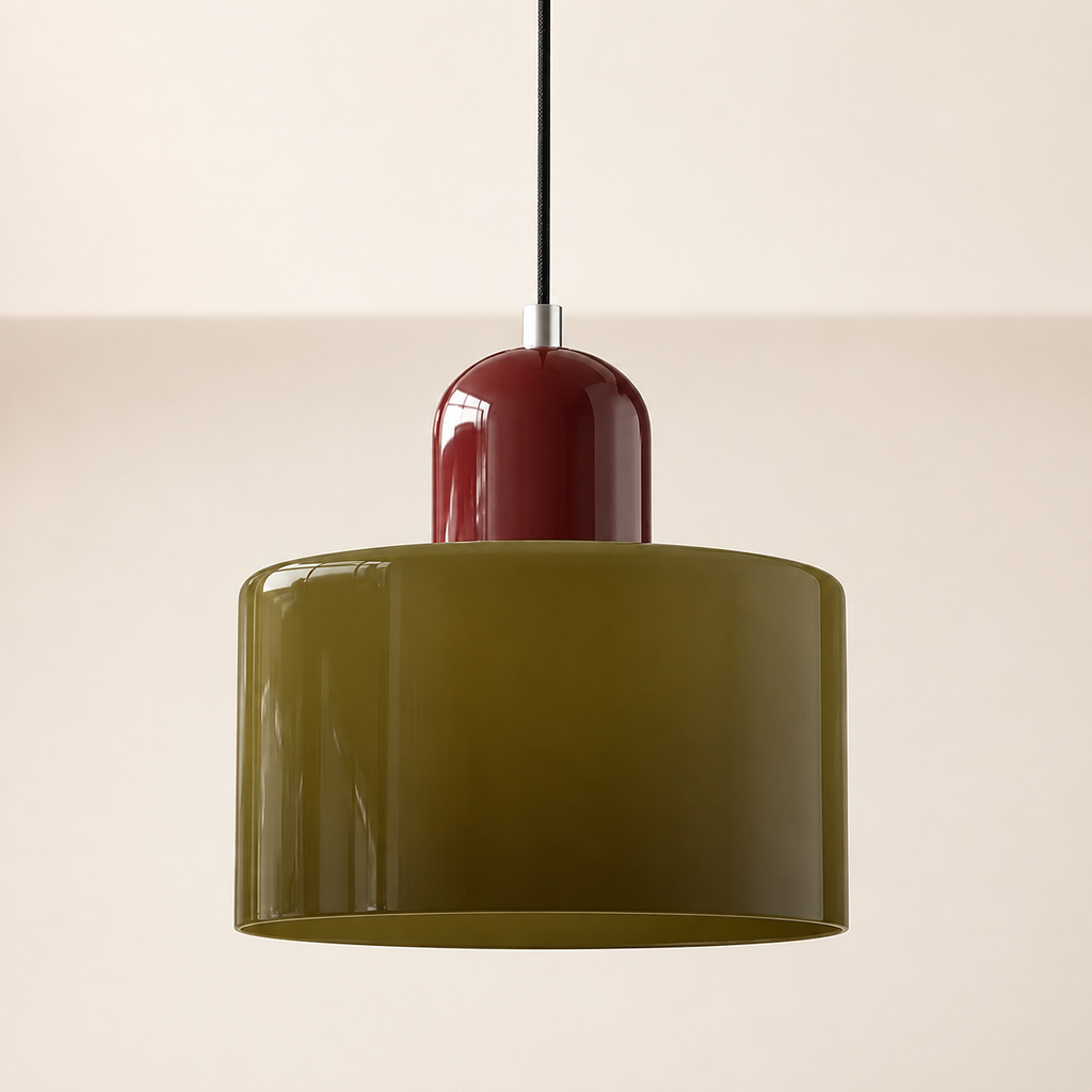 Dark green circular glass pendant light with a burgundy cap on a warm studio wall