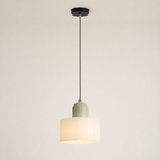 White circular glass pendant light shown with its long adjustable cord and canopy