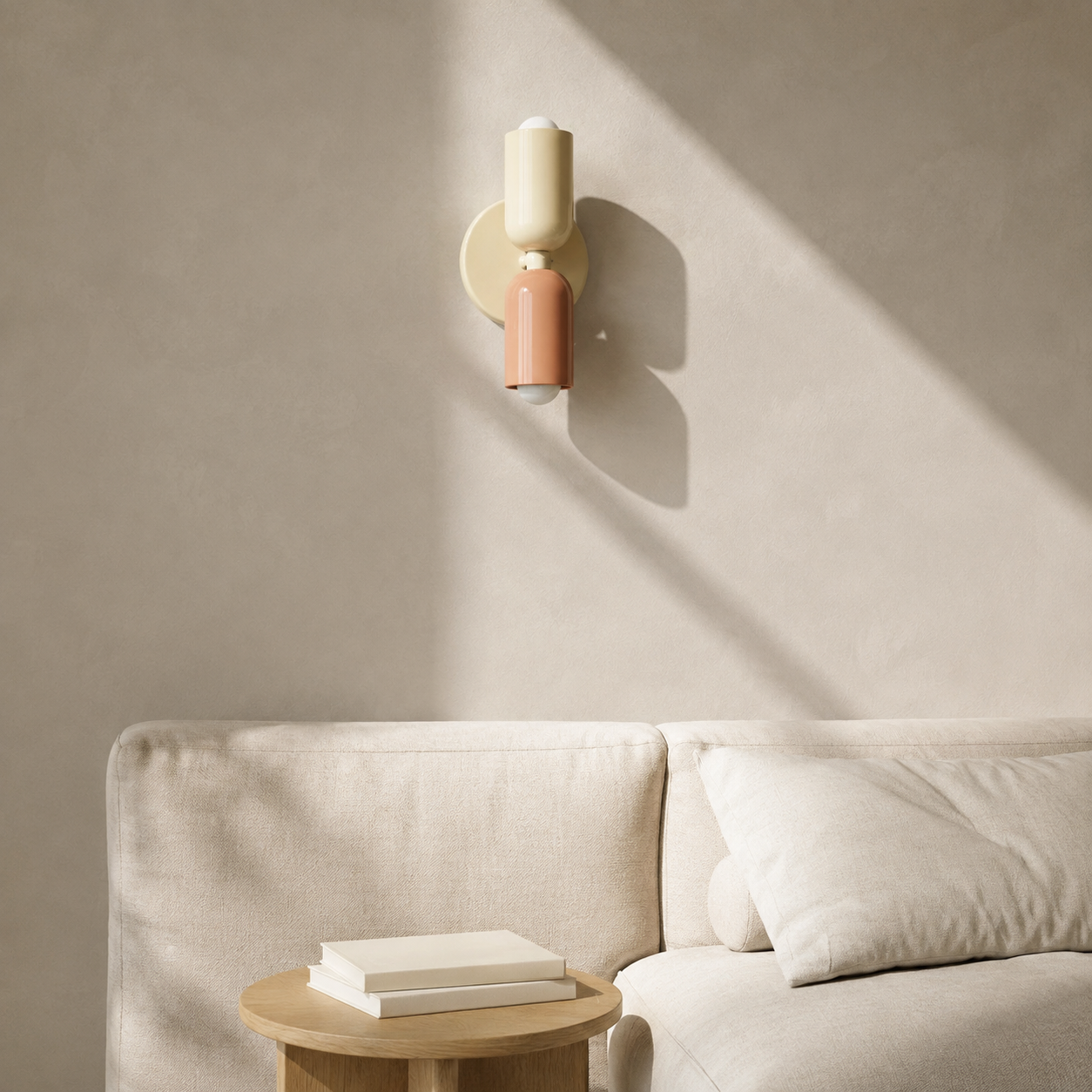 Beige and pink double Scandinavian wall sconce above an American linen sofa