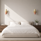 Two beige and pink double Scandinavian wall sconces above an upholstered bed