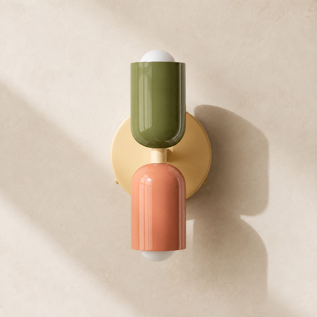 Green and pink double Scandinavian wall sconce on a warm cream wall