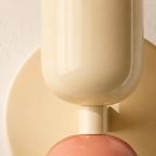 Close detail of the beige and pink double Scandinavian wall sconce