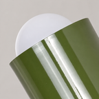 Close detail of the green shade and globe on a Scandinavian wall sconce
