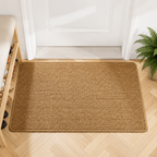 Brown faux jute doormat placed inside a bright white entry door.