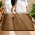 Brown faux jute doormat underfoot in a sunlit home entrance.