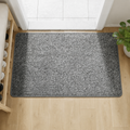 Grey faux jute doormat with dark bound edge on a pale oak floor.
