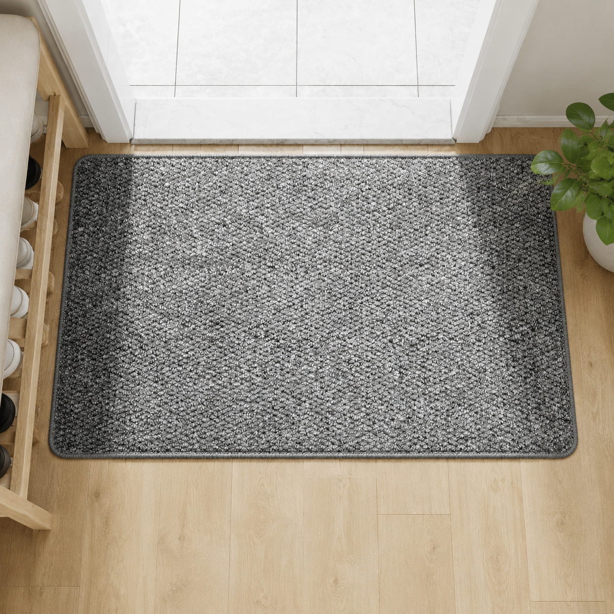 Grey faux jute doormat with dark bound edge on a pale oak floor.