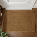 Brown faux jute doormat shown from above beneath a white door.