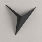 Black geometric star LED wall sconce on a warm light-gray wall