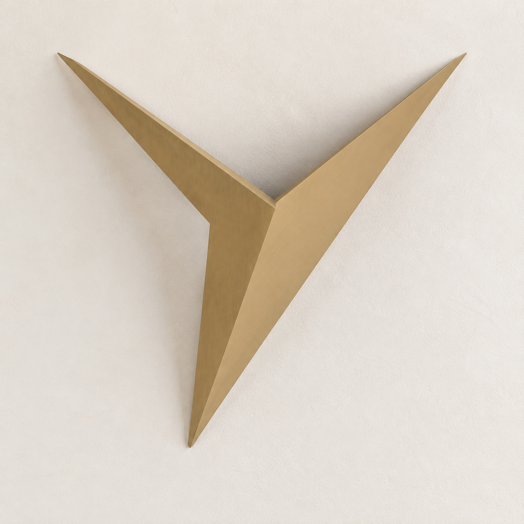 Gold geometric star LED wall sconce on a soft ivory wall