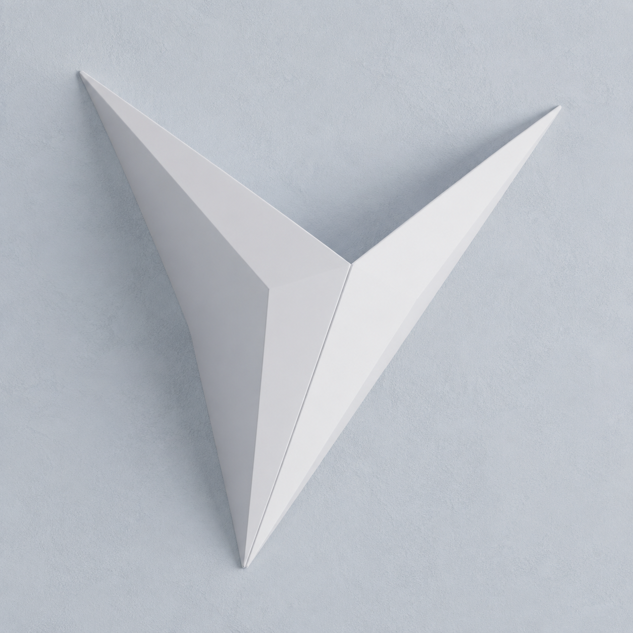 White geometric star LED wall sconce on a pale blue-gray wall