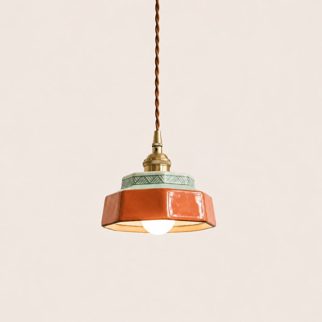 Terracotta hand-painted ceramic pendant light on an off-white studio background