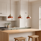 Three terracotta hand-painted ceramic pendant lights above a shaker kitchen island