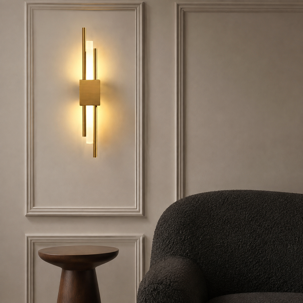 Gold dual-rod LED wall sconce glowing above a walnut pedestal table