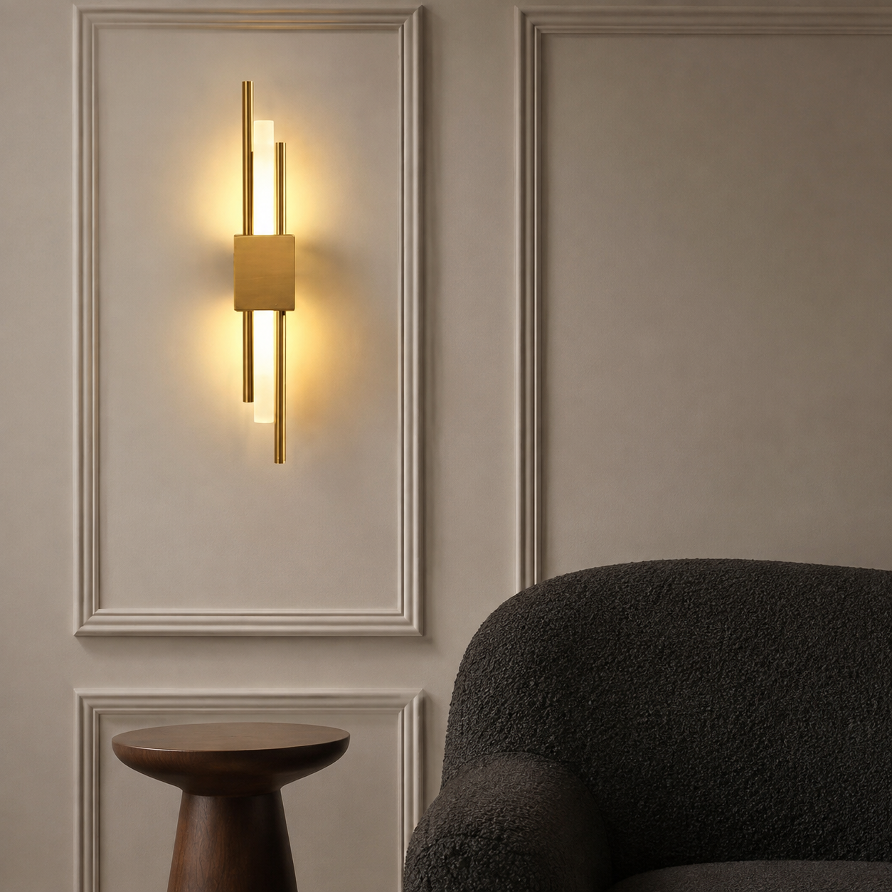 Gold dual-rod LED wall sconce glowing above a walnut pedestal table
