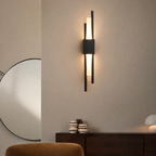 Black dual-rod LED wall sconce above a walnut living room credenza