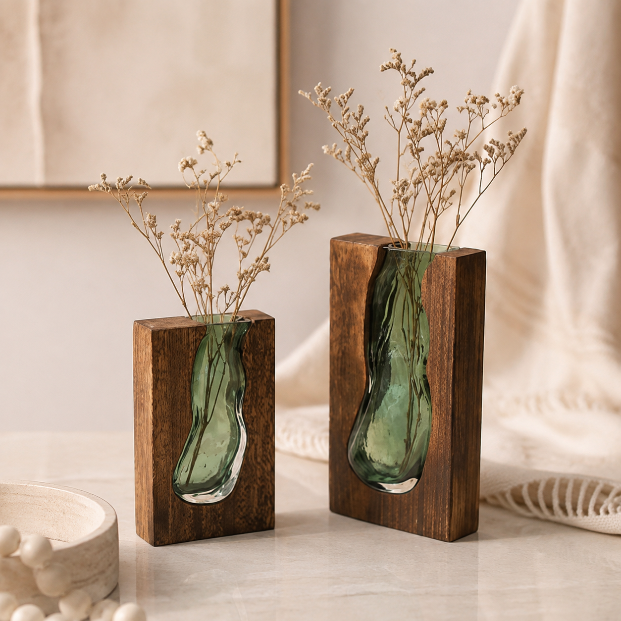 Two Nordic wood and green glass vases with delicate dried stems