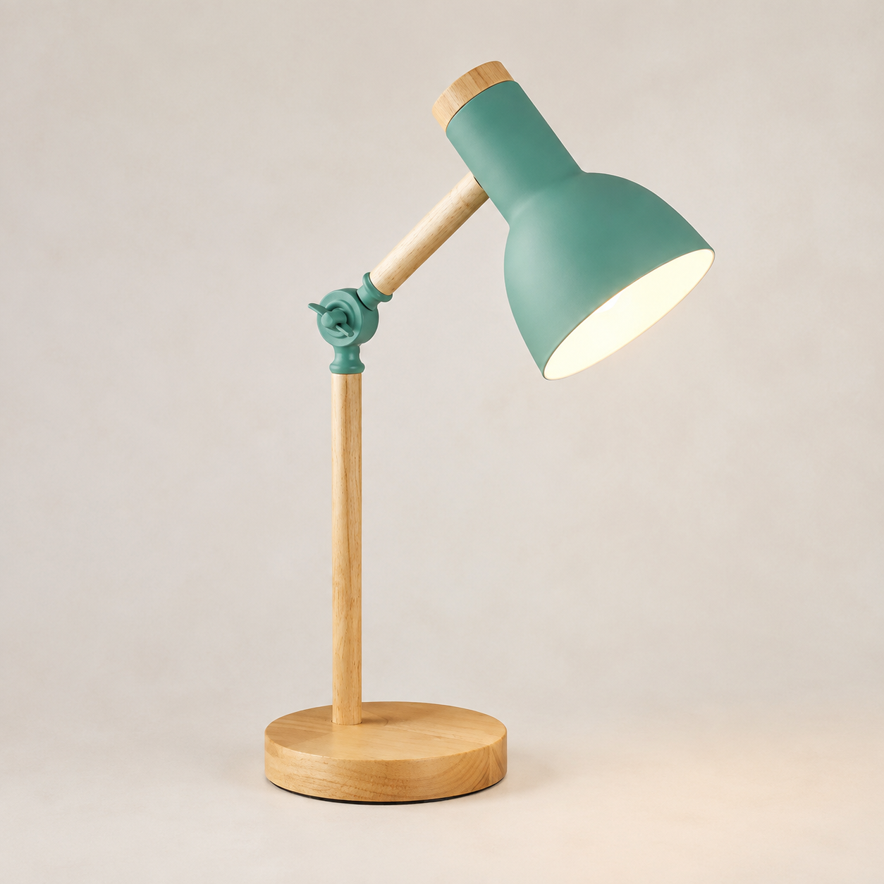 Green wooden desk lamp isolated on a pale studio background.