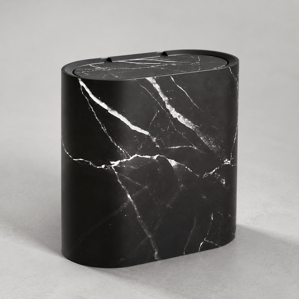 Black marble oval trash can on a neutral gray studio background
