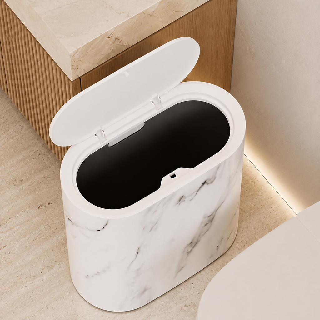 Open cream marble oval trash can viewed from above in a modern bathroom