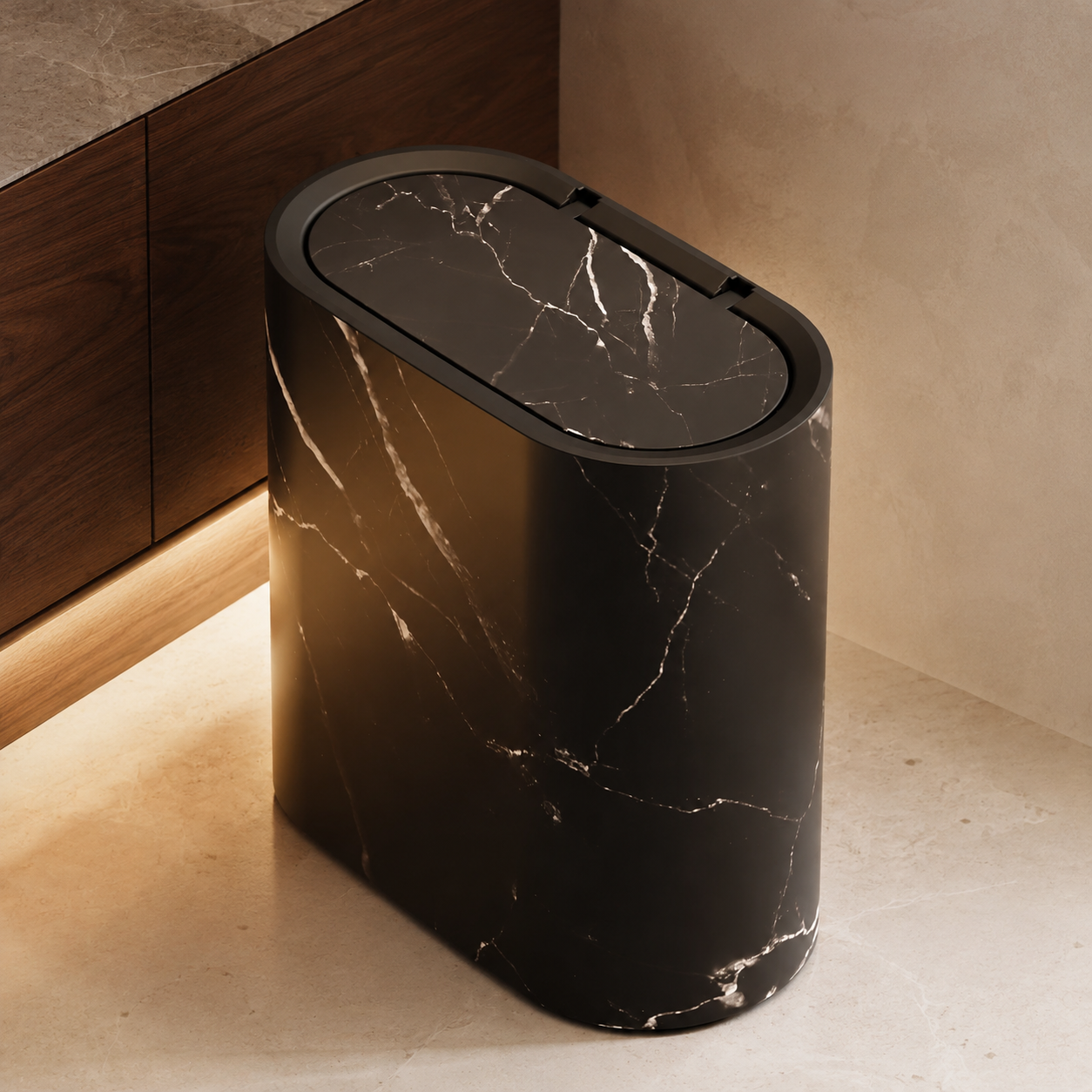 Black marble oval trash can beside dark walnut bathroom cabinetry