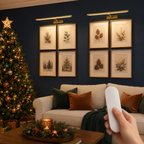 Two gold rechargeable picture lights controlled by a blank remote in a holiday room