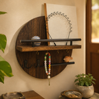 Brown and black round wooden key holder with shelf mounted in a warm entryway.