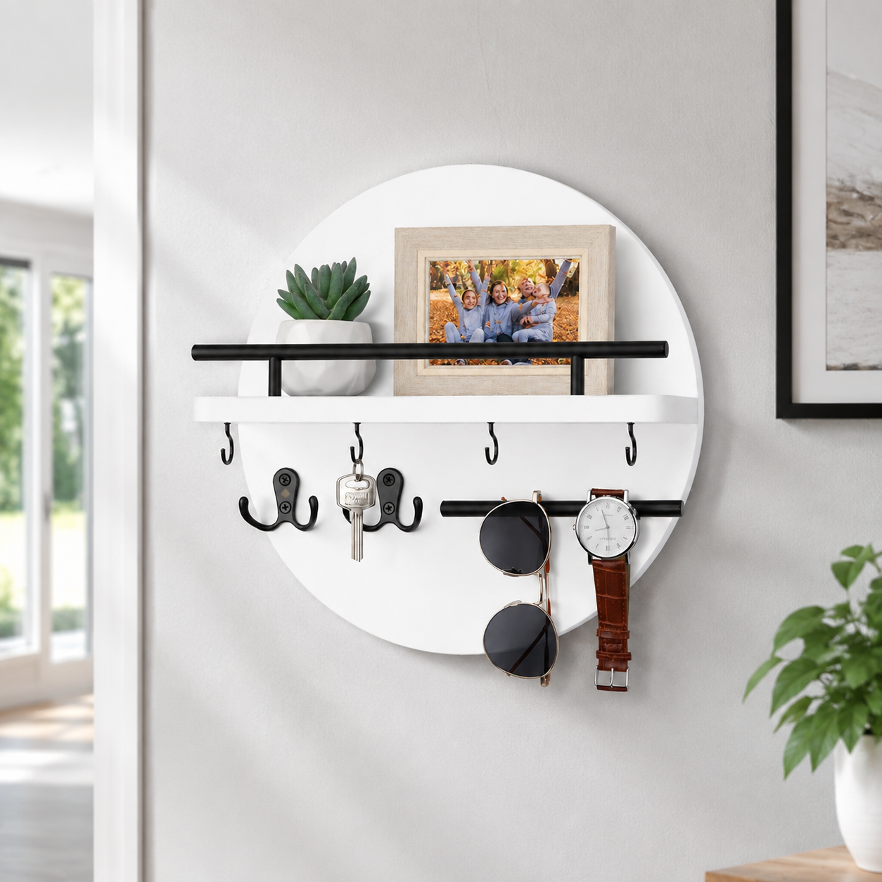 White and black round wooden key holder mounted on a clean light grey wall.