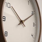 Close view of the wall clock dial, wood frame and brass brown hands