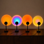 Four black sunset projector lamps casting orange and multicolor halos