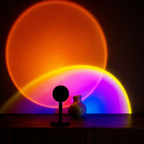 Black sunset projector lamp casting overlapping orange and rainbow halos