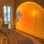 Warm sunset halo projected across a modern American bedroom wall