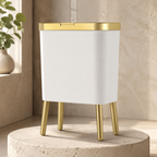 White trash can variant with gold trim on a rounded limestone pedestal.