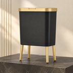 Black trash can variant with gold trim on a dark stone pedestal.