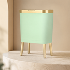 Light green trash can variant with gold trim on a cream stone pedestal.