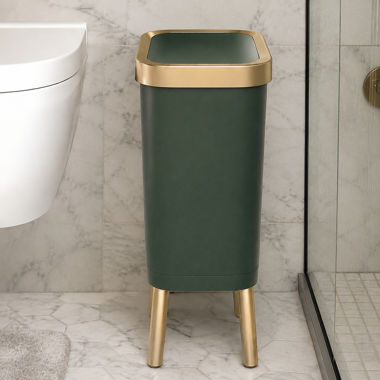 Deep green trash can with gold trim positioned beside a tiled shower.