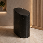 Black marble oval trash can beside a modern vanity