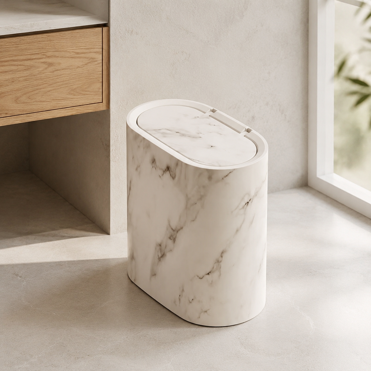 Cream marble oval trash can beside a modern bathroom vanity