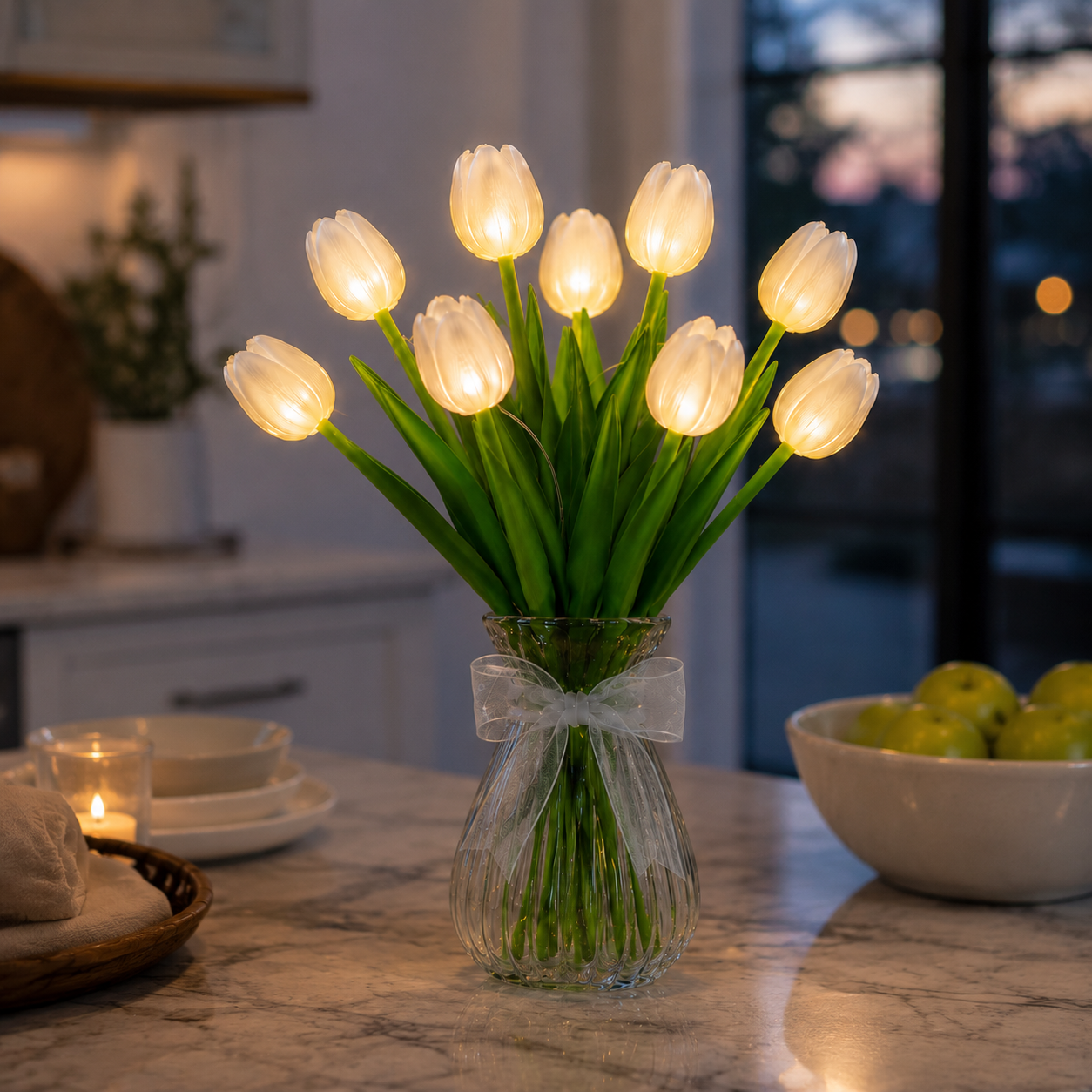 Warm white tulip flower lamp in a clear glass vase on a kitchen counter