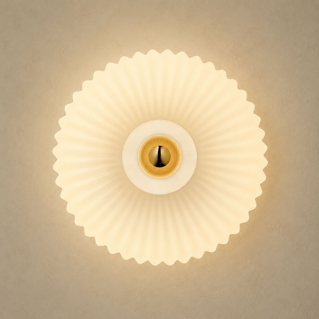 Front view of cream ribbed glass wall sconce with brass center
