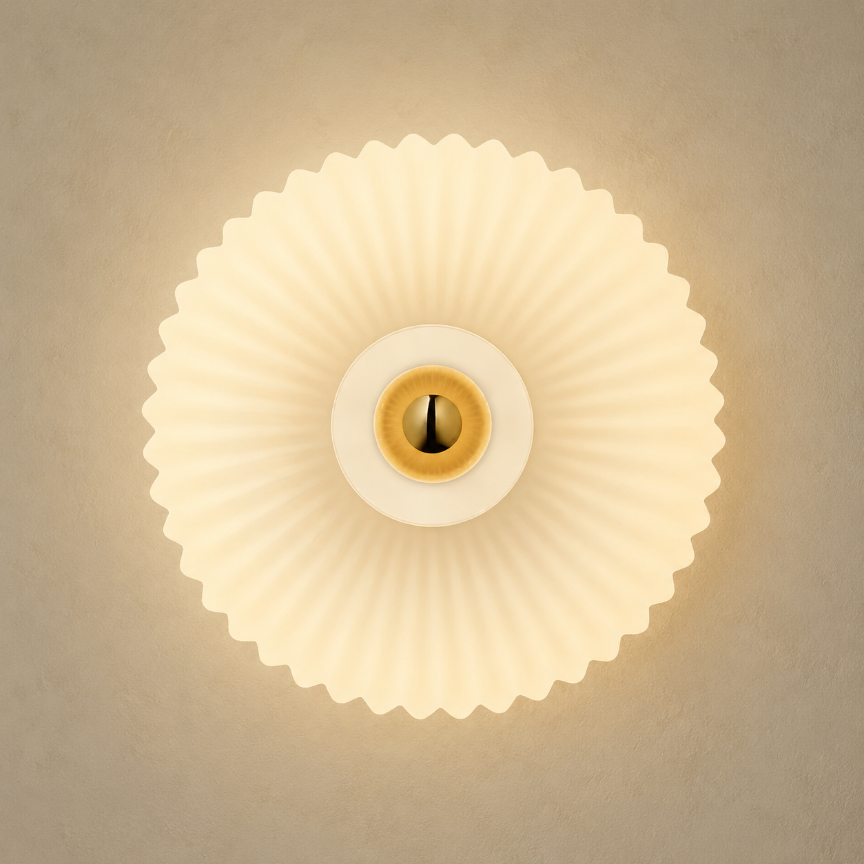 Front view of cream ribbed glass wall sconce with brass center