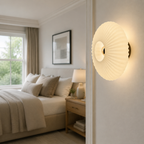 Cream ribbed glass wall sconce at an elegant bedroom entry