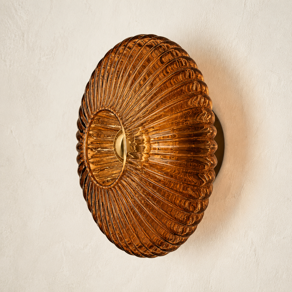 Cognac brown ribbed glass wall sconce on an ivory plaster wall