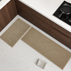 Two khaki faux sisal kitchen mats arranged beside walnut cabinets