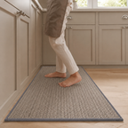 Gray faux sisal kitchen runner rug with a dark bound edge