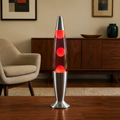 Red wax motion lava lamp glowing in an American mid-century living room